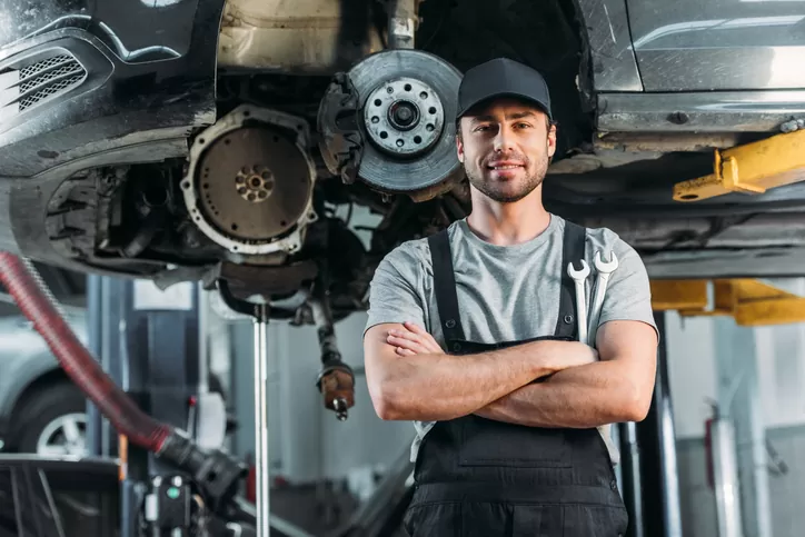 Auto mechanic inspecting car parts and specifications